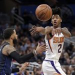 FILE - In this March 24, 2018, file photo, then-Phoenix Suns' Elfrid Payton passes the ball around Orlando Magic's D.J. Augustin, left, during the second half of an NBA basketball game, in Orlando, Fla. Payton and Julius Randle know very well they likely wouldn't have wound up in New Orleans if the Pelicans hadn't lost DeMarcus Cousins and Rajon Rondo in free agency. Randle and Payton are less accomplished, but younger and eager to see if playing alongside Anthony Davis helps them reach new plateaus.(AP Photo/John Raoux, File)