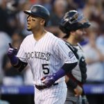 Colorado Rockies' Carlos Gonzalez gestures as he crosses home plate after hitting a solo home run off Arizona Diamondbacks relief pitcher Jorge De La Rosa during the third inning of a baseball game Wednesday, July 11, 2018, in Denver. Arizona catcher Alex Avila is in back. (AP Photo/David Zalubowski)