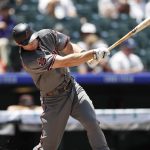 Arizona Diamondbacks' Paul Goldschmidt follows through with his swing after connecting for a single off Colorado Rockies starting pitcher Kyle Freeland in the first inning of a baseball game Thursday, July 12, 2018, in Denver. (AP Photo/David Zalubowski)