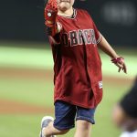 Using a 3-D printed glove, 8-year-old Hailey Dawson throws out the ceremonial first pitch prior to a baseball game between the Arizona Diamondbacks and Colorado Rockies, Saturday, July 21, 2018, in Phoenix. Dawson was born with Poland Syndrome which caused the underdevelopment of her right hand. (AP Photo/Ralph Freso)