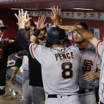 San Francisco Giants' Hunter Pence (8) celebrates his run scored against the Arizona Diamondbacks with assistant hitting coach Rick Schu, left, Austin Slater, second from right, and Nick Hundley, right, during the fifth inning of a baseball game Sunday, July 1, 2018, in Phoenix. (AP Photo/Ross D. Franklin)