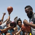 James Harden signs a basketball for a fan during a training camp for USA basketball, Thursday, July 26, 2018, in Las Vegas. (AP Photo/John Locher)