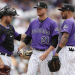 Colorado Rockies starting pitcher Kyle Freeland, center, is congratulated by catcher Chris Iannetta, left, and first baseman Ian Desmond as Freeland waits to be pulled form the mound after retiring Arizona Diamondbacks' Ketel Marte in the sixth inning of a baseball game Thursday, July 12, 2018, in Denver. (AP Photo/David Zalubowski)
