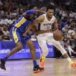 Sacramento Kings rookie forward Marvin Bagley III, right, drives to the basket against Golden State Warriors forward Marcus Derrickson during the second half of an NBA summer league basketball game Tuesday, July 3, 2018, in Sacramento, Calif. (AP Photo/Rich Pedroncelli)