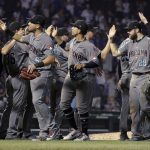 Arizona Diamondbacks' David Peralta, Jon Jay and Steven Souza Jr., from left in front, celebrate the team's 5-1 win over the Chicago Cubs in a baseball game Tuesday, July 24, 2018, in Chicago. (AP Photo/Charles Rex Arbogast)