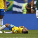 Brazil's Neymar lies on the ground during the round of 16 match between Brazil and Mexico at the 2018 soccer World Cup in the Samara Arena, in Samara, Russia, Monday, July 2, 2018. (AP Photo/Frank Augstein)