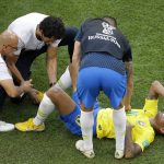 Brazil's Neymar receives medical care during the round of 16 match between Brazil and Mexico at the 2018 soccer World Cup in the Samara Arena, in Samara, Russia, Monday, July 2, 2018. (AP Photo/Sergei Grits)