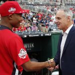 Major League Baseball Commissioner Rob Manfred, right, shakes hands with ball boy Spenser Clark before the MLB Home Run Derby, at Nationals Park, Monday, July 16, 2018 in Washington. The 89th MLB baseball All-Star Game will be played Tuesday. (AP Photo/Alex Brandon)