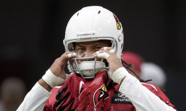 Arizona Cardinals wide receiver Larry Fitzgerald (11) puts on his helmet during the first day of NF...