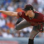 Arizona Diamondbacks starting pitcher Shelby Miller watches a throw to a Colorado Rockies batter during the first inning of a baseball game Wednesday, July 11, 2018, in Denver. (AP Photo/David Zalubowski)