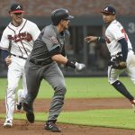 Arizona Diamondbacks' Nick Ahmed, front left, is chased in a rundown by Atlanta Braves shortstop Dansby Swanson, back left, who tags him out with third baseman Johan Camargo, right, watching during the third inning of a baseball game Friday, July 13, 2018, in Atlanta. (AP Photo/John Amis)