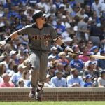 Arizona Diamondbacks' Nick Ahmed (13) watches his grand slam during the fifth inning of a baseball game  against the Chicago Cubs, Thursday, July 26, 2018, in Chicago. (AP Photo/David Banks)
