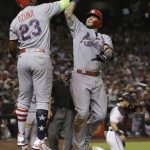 St. Louis Cardinals' Yadier Molina celebrates with Marcell Ozuna (23) after hitting a three-run home run during the seventh inning of the team's baseball game against the Arizona Diamondbacks, Wednesday, July 4, 2018, in Phoenix. (AP Photo/Rick Scuteri)
