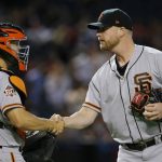San Francisco Giants relief pitcher Will Smith, right, shakes hands with catcher Nick Hundley, left, after the final out in the ninth inning of a baseball game against the Arizona Diamondbacks, Sunday, July 1, 2018, in Phoenix. (AP Photo/Ross D. Franklin)