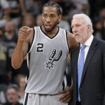 FILE - In this March 12, 2016, file photo, San Antonio Spurs forward Kawhi Leonard talks with coach Gregg Popovich during the second half of the team's NBA basketball game against the Oklahoma City Thunder in San Antonio. Leonard declined an invitation to be with USA Basketball this week for its two-practice minicamp in Las Vegas. (AP Photo/Darren Abate, File)