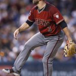 Arizona Diamondbacks infielder Daniel Descalso works as a relief pitcher in the fourth inning of the team's baseball game against the Colorado Rockies on Wednesday, July 11, 2018, in Denver. (AP Photo/David Zalubowski)