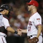 Arizona Diamondbacks relief pitcher Brad Boxberger (31) slaps hands with catcher Jeff Mathis, left, after the final out of the team'sbaseball game against the St. Louis Cardinals on Tuesday, July 3, 2018, in Phoenix. The Diamondbacks defeated the Cardinals 4-2. (AP Photo/Ross D. Franklin)