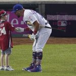 Chicago Cubs Kyle Schwarber speaks to a child after batting in the MLB Home Run Derby, at Nationals Park, Monday, July 16, 2018 in Washington. The 89th MLB baseball All-Star Game will be played Tuesday. (AP Photo/Carolyn Kaster)