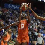 Connecticut Sun forward Chiney Ogwumike (13) drives between Phoenix Mercury defenders Yvonne Turner, left, and DeWanna Bonner in the second half of WNBA basketball game action Friday, July 13, 2018, in Uncasville, Conn. (Sean D. Elliot/The Day via AP)