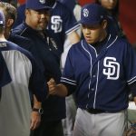 San Diego Padres relief pitcher Kazuhisa Makita, right, of Japan, gets a fist-bump from manager Andy Green, left, as interpreter Kenji Aoshima, middle, looks on after Makita threw one pitch for the final out by the Arizona Diamondbacks during the eighth inning of a baseball game Thursday, July 5, 2018, in Phoenix. The Padres defeated the Diamondbacks 6-3. (AP Photo/Ross D. Franklin)
