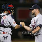 St. Louis Cardinals relief pitcher Bud Norris, right, shakes hands with catcher Yadier Molina after the final out in the ninth inning of a baseball game against the Arizona Diamondbacks, Monday, July 2, 2018, in Phoenix. The Cardinals defeated the Diamondbacks 6-3. (AP Photo/Ross D. Franklin)