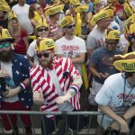 
              Jeremiah Bruckart, left, and Jared Johnston of the Queens borough of New York dance to the music before the start of the Nathan's Famous Fourth of July hot dog eating contest, Wednesday, July 4, 2018, in New York's Coney Island. (AP Photo/Mary Altaffer)
            