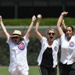 Orange is the New Black actresses, Kate Mulgrew, left, Taylor Schilling, center, and Dascha Polanco, right, react after throwing out a ceremonial first pitch before a baseball game between the Chicago Cubs and the Arizona Diamondbacks, Thursday, July 26, 2018, in Chicago. (AP Photo/David Banks)