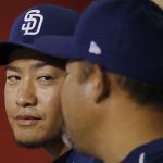 San Diego Padres relief pitcher Kazuhisa Makita, left, of Japan, listens to interpreter Kenji Aoshima after Makita threw one pitch for the final out against the Arizona Diamondbacks during the eighth inning of a baseball game Thursday, July 5, 2018, in Phoenix. The Padres defeated the Diamondbacks 6-3. (AP Photo/Ross D. Franklin)