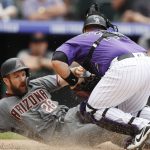 Colorado Rockies catcher Chris Iannetta, right, tags out Arizona Diamondbacks' Steven Souza Jr. at home plate as he tries to score on a ground ball hit by John Ryan Murphy in the sixth inning of a baseball game Thursday, July 12, 2018, in Denver. (AP Photo/David Zalubowski)