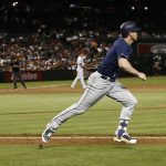 San Diego Padres' Wil Myers, middle, tosses his bat away on his way to an RBI triple as Arizona Diamondbacks starting pitcher Shelby Miller (26) watches the ball during the sixth inning of a baseball game Thursday, July 5, 2018, in Phoenix. (AP Photo/Ross D. Franklin)