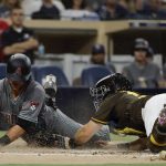 The Arizona Diamondbacks' Jeff Mathis, left, scores from second base off an RBI-single by Jon Jay as San Diego Padres catcher Austin Hedges, right, is late with the tag during the third inning of a baseball game Friday, July 27, 2018, in San Diego. (AP Photo/Gregory Bull)