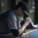 Arizona Diamondbacks starting pitcher Clay Buchholz sits in the dugout during the third inning of the team's baseball game against the Chicago Cubs on Tuesday, July 24, 2018, in Chicago. (AP Photo/Charles Rex Arbogast)