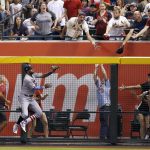 St. Louis Cardinals' Jose Martinez jumps but is unable to make a play on a three-run home run hit by Arizona Diamondbacks' Paul Goldschmidt during the fifth inning of a baseball game Tuesday, July 3, 2018, in Phoenix. (AP Photo/Ross D. Franklin)