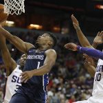 Dallas Mavericks' Dennis Smith Jr., second from left, shoots around Phoenix Suns' Davon Reed, left, and Shaquille Harrison, right, during the first half of an NBA summer league basketball game Friday, July 6, 2018, in Las Vegas. (AP Photo/John Locher)