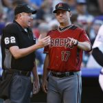 Home plate umpire Chad Whitson, left, confers with Arizona Diamondbacks manager Torey Lovullo after Whitson called a balk on relief pitcher Jorge De La Rosa, scoring Colorado Rockies' Gerardo Perra in the second inning of a baseball game Wednesday, July 11, 2018, in Denver. (AP Photo/David Zalubowski)