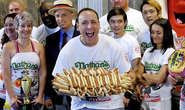 Nathan's Famous Men's Champion Joey Chestnut poses with 72 hot dogs during Nathan's Famous Internat...