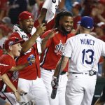 Los Angeles Dodgers Max Muncy (13) is congratulated by his National League teammates during the MLB Home Run Derby, at Nationals Park, Monday, July 16, 2018 in Washington. The 89th MLB baseball All-Star Game will be played Tuesday. (AP Photo/Patrick Semansky)