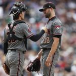 Arizona Diamondbacks catcher John Ryan Murphy, left, congratulaTes starting pitcher Robbie Ray as he waits to be pulled form the mound after walking Colorado Rockies' Chris Iannetta in the sixth inning of a baseball game Thursday, July 12, 2018, in Denver. (AP Photo/David Zalubowski)