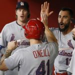 St. Louis Cardinals' Tyler O'Neill (41) celebrates his run scored against the Arizona Diamondbacks with Miles Mikolas, left, Matt Carpenter, second from right, and Greg Garcia, right, during the first inning of a baseball game Monday, July 2, 2018, in Phoenix. (AP Photo/Ross D. Franklin)
