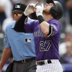 Colorado Rockies' Trevor Story gestures as he crosses home plate after hitting a solo home run off Arizona Diamondbacks relief pitcher Randall Delgado during the seventh inning of a baseball game Thursday, July 12, 2018, in Denver. (AP Photo/David Zalubowski)