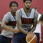 Paul George, right, drives into Miles Turner during a training camp for USA Basketball, Friday, July 27, 2018, in Las Vegas. (AP Photo/John Locher)
