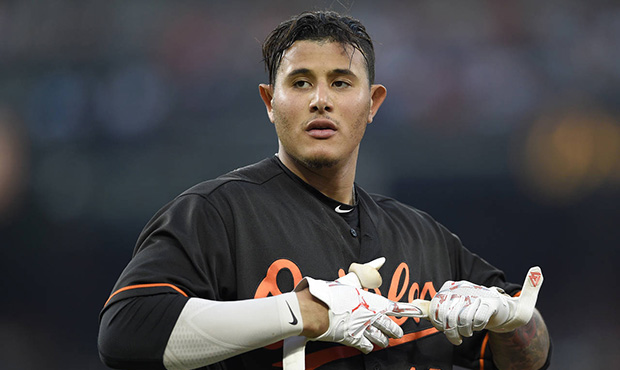 Baltimore Orioles' Manny Machado takes off his batting gloves after he flied out during the third i...