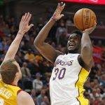 FILE - In this April 3, 2018, file photo, then-Los Angeles Lakers forward Julius Randle (30) shoots as Utah Jazz forward Joe Ingles, left, defends during the first half of an NBA basketball game, in Salt Lake City. Randle and Elfrid Payton know very well they likely wouldn't have wound up in New Orleans if the Pelicans hadn't lost DeMarcus Cousins and Rajon Rondo in free agency. Randle and Payton are less accomplished, but younger and eager to see if playing alongside Anthony Davis helps them reach new plateaus. (AP Photo/Rick Bowmer, File)