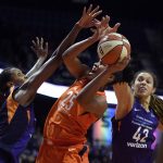 Connecticut Sun forward Alyssa Thomas is fouled by Phoenix Mercury center Brittney Griner (42) as Mercury's Angel Robinson, left, defends in the second half of WNBA basketball game action Friday, July 13, 2018, in Uncasville, Conn. (Sean D. Elliot/The Day via AP)/The Day via AP)