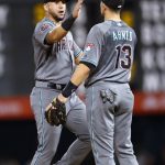 Arizona Diamondbacks right fielder David Peralta, left, celebrates with shortstop Nick Ahmed after the team's 5-3 win in a baseball game against the Colorado Rockies on Tuesday, July 10, 2018, in Denver. (AP Photo/David Zalubowski)