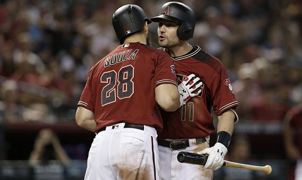 Arizona Diamondbacks' A.J. Pollock (11) is to be held back by Steven Souza Jr. after getting tossed...