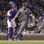 Arizona Diamondbacks' Paul Goldschmidt (44) scores past Chicago Cubs catcher Victor Caratini on a double by Steven Souza Jr. during the fifth inning of a baseball game Tuesday, July 24, 2018, in Chicago. (AP Photo/Charles Rex Arbogast)