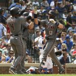 Arizona Diamondbacks' Nick Ahmed (13) is greeted by Ketel Marte (4) after hitting a grand slam  against the Chicago Cubs during the fifth inning of a baseball game, Thursday, July 26, 2018, in Chicago. (AP Photo/David Banks)