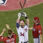 Washington Nationals Bryce Harper holds up the trophy after winning the the Major League Baseball Home Run Derby Monday, July 16, 2018, in Washington. (AP Photo/Susan Walsh)