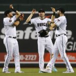 Arizona Diamondbacks' David Peralta, left, A.J. Pollock, middle, and Steven Souza Jr. celebrate the team's 3-1 win in a baseball game against the San Diego Padres on Friday, July 6, 2018, in Phoenix. (AP Photo/Ross D. Franklin)